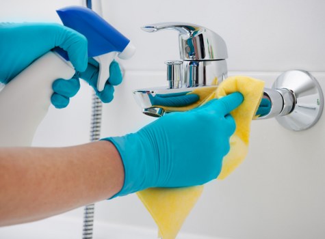Kitchen surfaces being wiped during move in cleaning