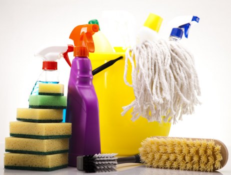 Technician using carpet cleaning equipment on a stained hallway carpet